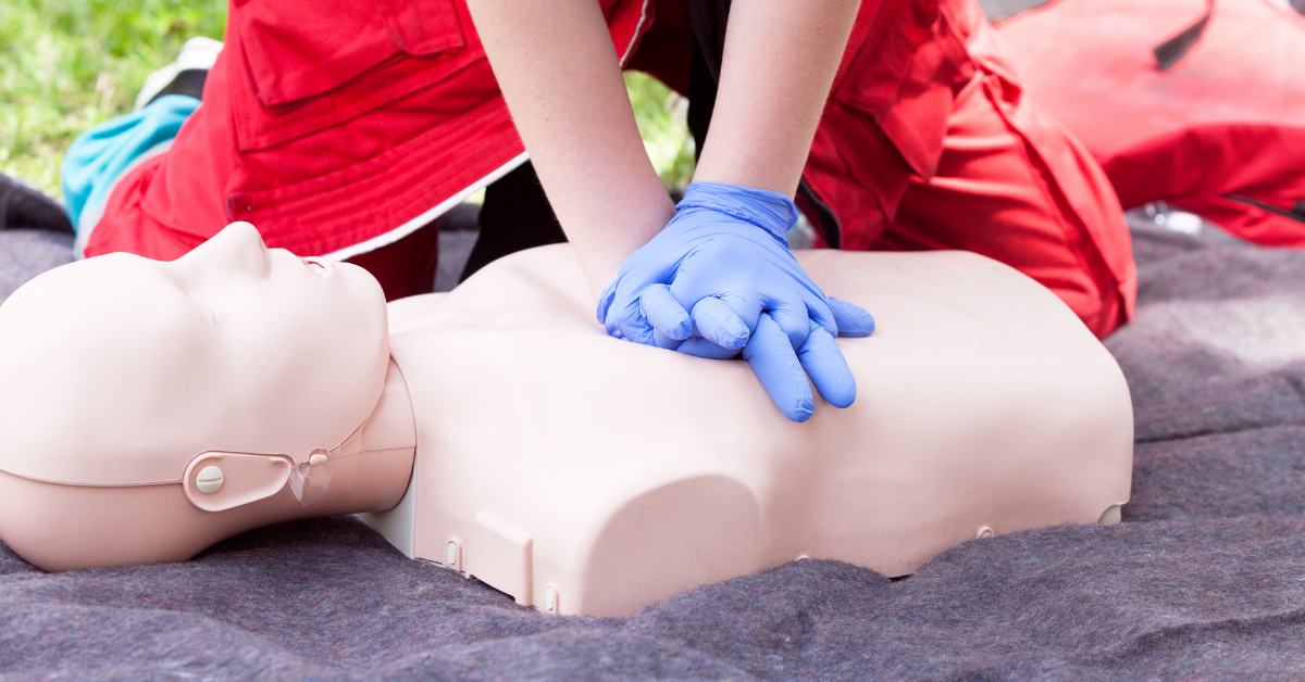 person practicing cpr on Annie dummy